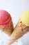 Yellow passion fruit and red strawberry ice cream cones