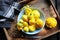 Yellow patisson, pattypan scallop squash vegetable on blue plate on white marble table background. Top view, flat lay