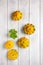 Yellow patissons or squash and a basil leaf on light wooden background