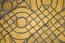 Yellow patterned paving tiles on the street, top view. Cement bricks, squared stone ground floor background texture