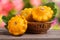 Yellow pattypan squash with leaf in a wicker basket on wooden table blurred background