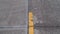 Yellow paved asphalt road. Intermittent concrete road. Blurred camera movement. Top plan over the road.