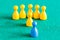 Yellow pawns with leader in front of one blue pawn