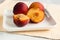 Yellow peaches on white square plate