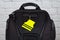 Yellow pedestrain safety reflector on a black backpack,. Concept