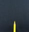 Yellow pencil lay on black craft paper background