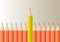 Yellow pencil standing out from orange pencils, leadership,difference and stand out from the crowd  business concept