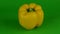 Yellow pepper rotates on green background. Chroma key background