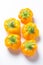 Yellow pepper on a white background. Several yellow peppers lie next to each other.