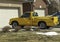 Yellow pickup near the garage