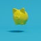 Yellow piggy bank floating on blue background