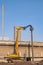 Yellow Pile drilling crawler crane working to install foundation pole near the old factory building