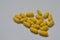 Yellow pills. Homeopathy, treatment, medicine. Pills, capsules on a white background.