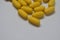 Yellow pills. Homeopathy, treatment, medicine. Pills, capsules on a white background.