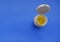 Yellow pills in white plastic container close-up on blue background. Copy space. Top view. Medicine, healthcare, prevention