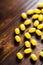 Yellow pills on a wooden table generated by ai