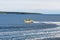 Yellow Pilot Boat Cutting Across Bay