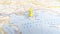 A yellow pin stuck in the island of Thasos on a map of Greece