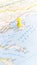 A yellow pin stuck in the island of Thasos on a map of Greece portrait