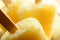 Yellow Pineapple Ice Lollies in Close Up with Wooden Sticks
