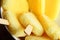 Yellow Pineapple Ice Lollies Grouped in White Bowl Overhead Closeup