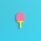 Yellow ping pong racket on bright blue background in pastel colors. Minimalism concept