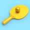 Yellow ping pong racket for table tennis with gold ball isolated on blue