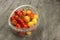 Yellow and pink cherries in a plastic container