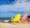 Yellow and pink colorful lounge chairs on a beach in Florida