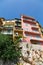 Yellow and Pink Condos Over Stone Wall