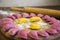 Yellow-pink dumplings, laid out for cooking, on a wooden rain. female hand sculpt dumplingsSlavic food. Ukrainian national dish. T