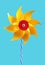 Yellow pinwheel toy, turqoise background