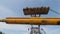 Yellow pipe in casing hangs on excavator bucket near trench