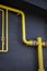 Yellow pipes, black wall