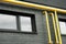 Yellow pipes, black wall and window