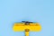 Yellow plane on blue copy space on the top for travel concept