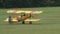 Yellow plane taxis away from the camera