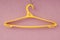 Yellow plastic coat-hanger