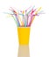 In a yellow plastic Cup colorful cocktail stick isolated