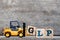 Yellow plastic forklift hold letter G to complete word GLP