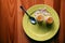 Yellow plate with empty eggshells left on the table after breakfast - flat lay