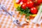 Yellow plate with vegetables and fork with tape measure on checkered tablecloth