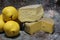 Yellow, plump quinces, arranged on the counter, quince fruit and long-maturing cheeses, montasio cheese and asiago cheese, Italian