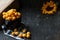 Yellow plums at the bowl with napkin on the black background. Ingredients for a jam. Food photography. Yellow sunflower, Autumn