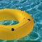 Yellow pool float, ring floating in a refreshing blue swimming pool.