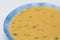 Yellow porridge in a blue plate