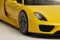 Yellow Porsche 918 Spyder model convertible car close up of front wheel