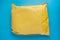 Yellow postal cardboard package on blue background