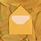 Yellow postal envelope on autumn yellow dry leaves.