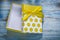 Yellow present box on wooden board holidays concept